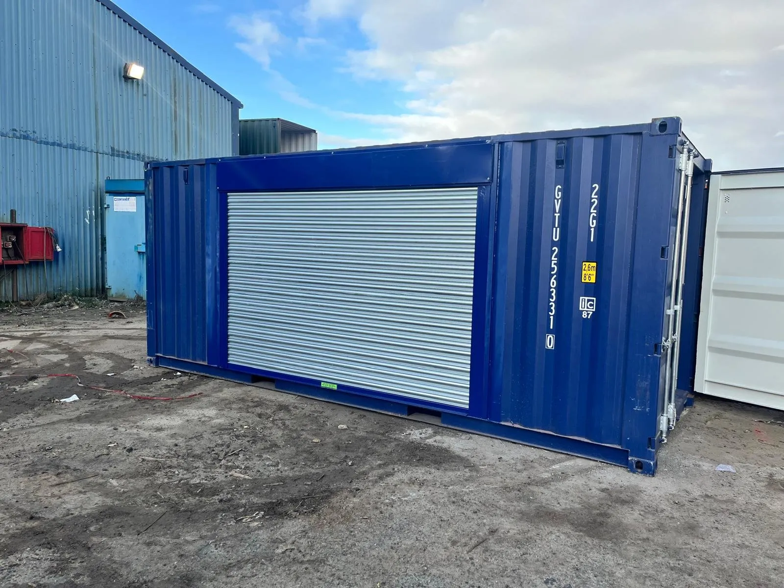 20ft container with a side roller door installed, painted in vibrant custom blue