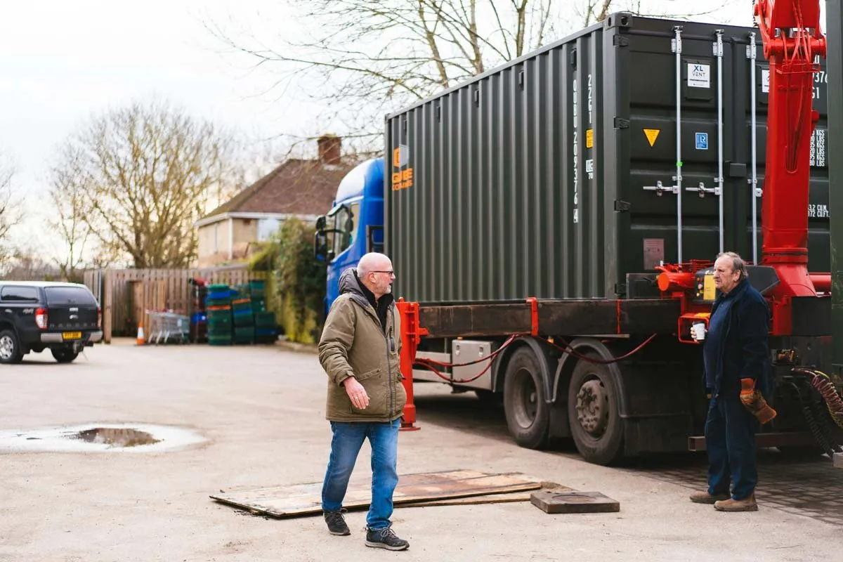 Container being positioned by hiab crane
