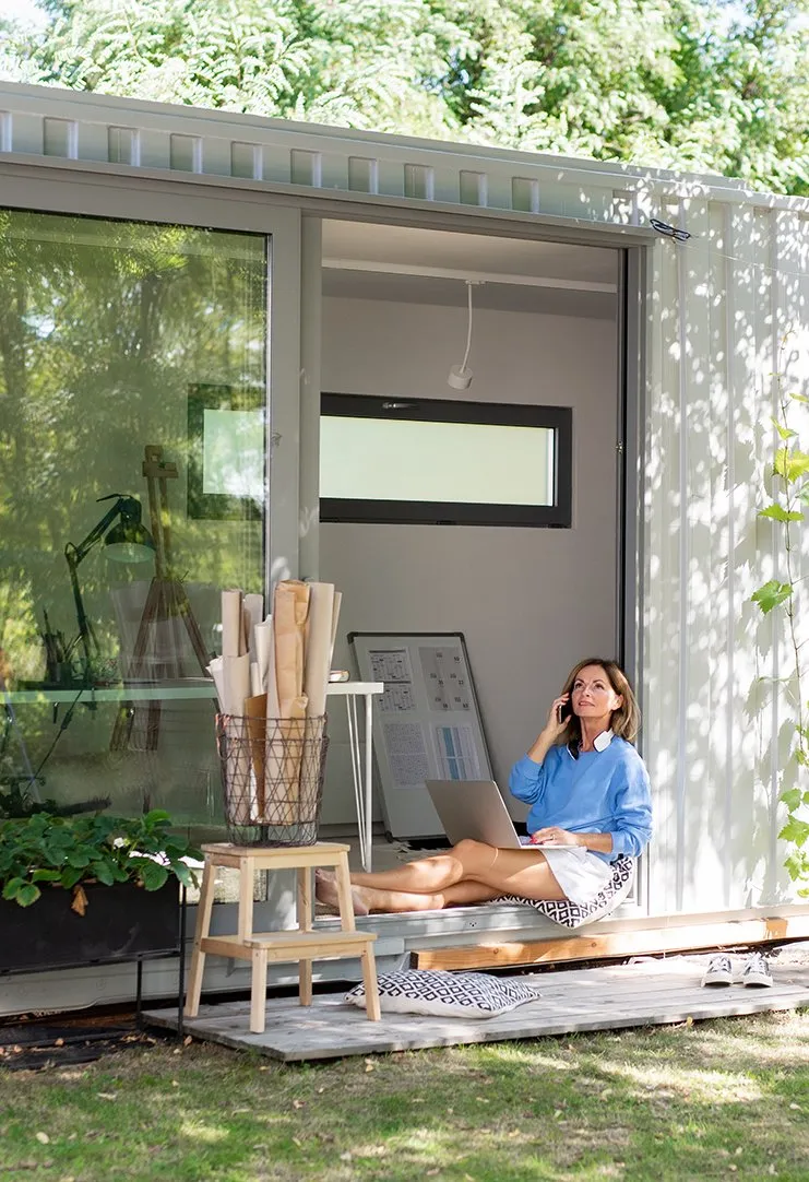 Finished container conversion in use as a glass-fronted garden office
